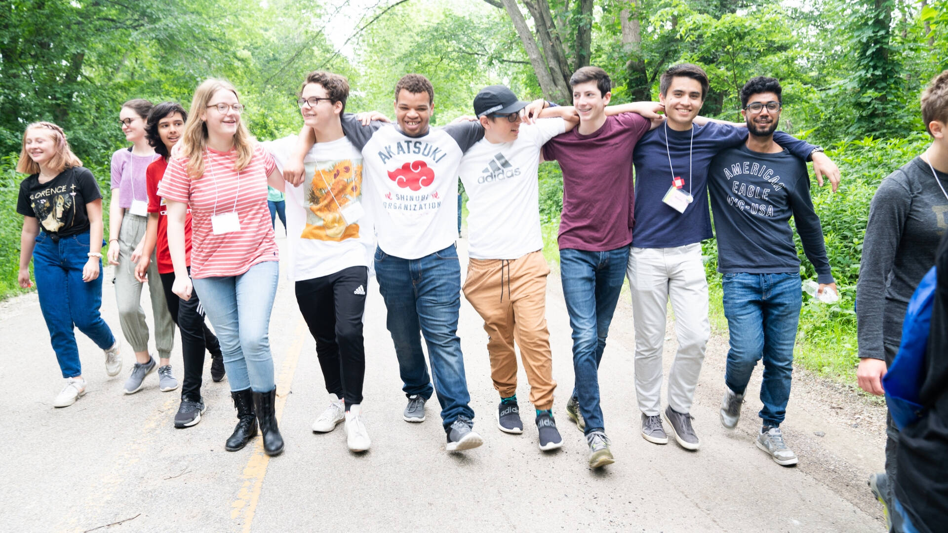 A line of students with their arms around each others' shoulders